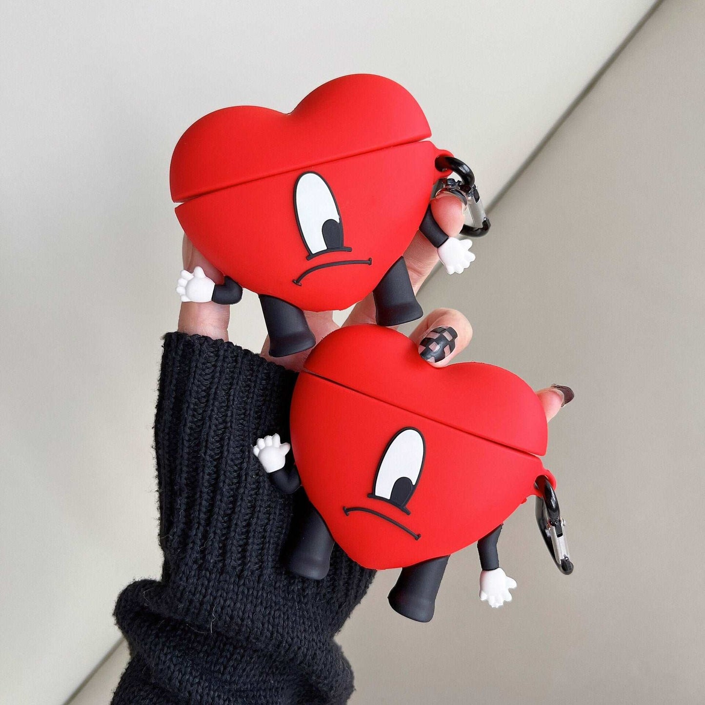 a person holding two heart shaped objects in their hands