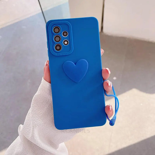 a person holding a blue phone case with a heart on it